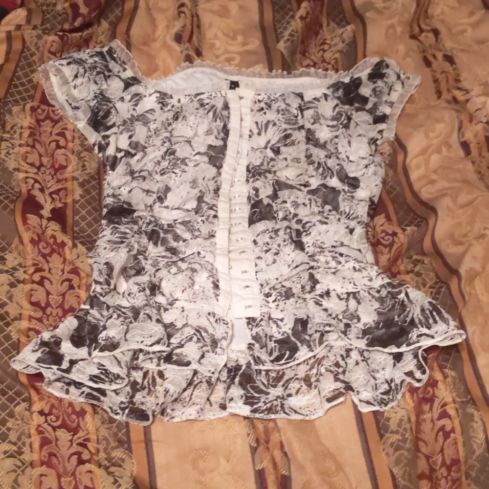 A button up shirt hangs off shoulders and thin....